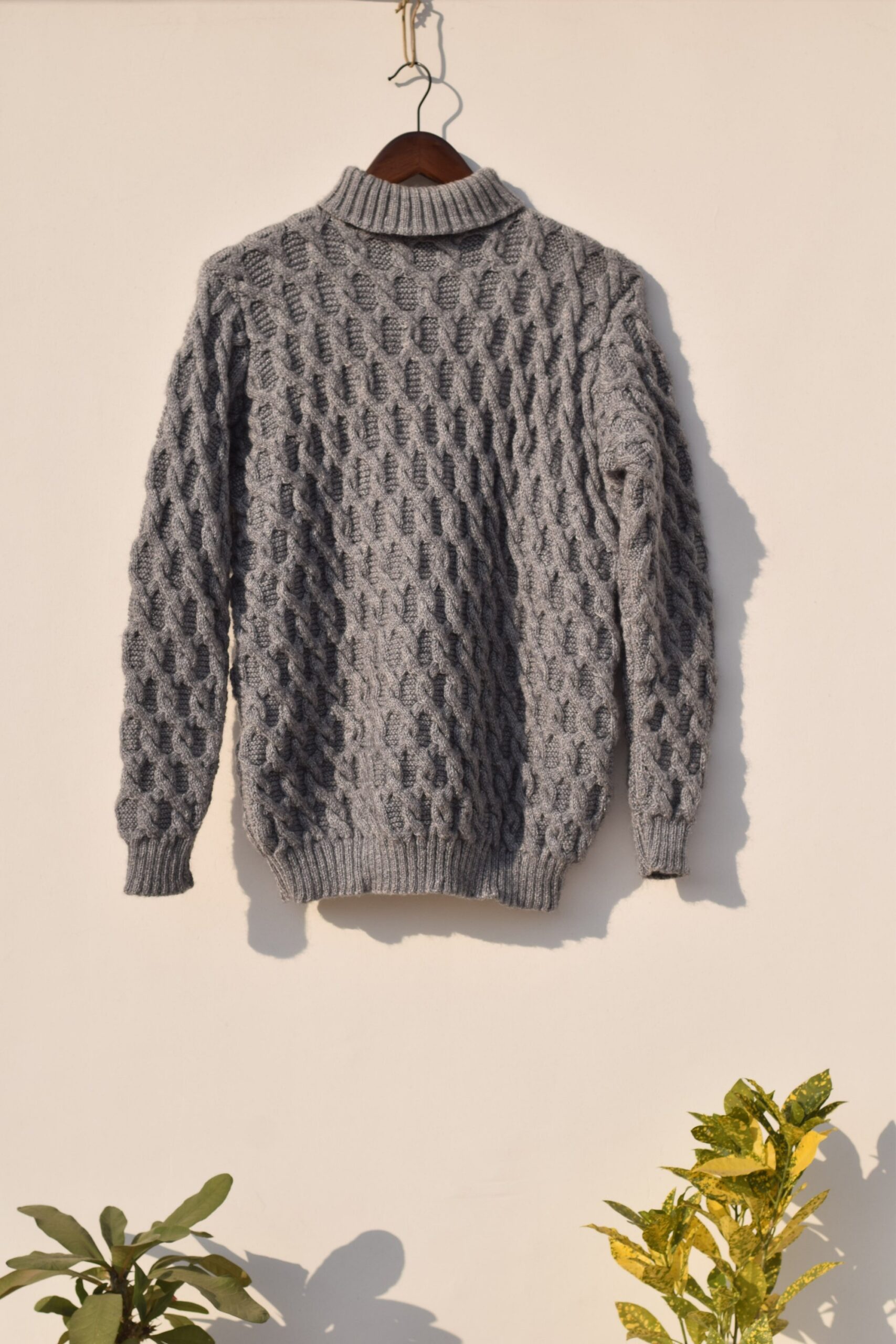 Grey handknitted cable design sweater